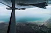 Småfly vingen sett over landskap og kystlinje ved Uvs-sjøen i Mongolia